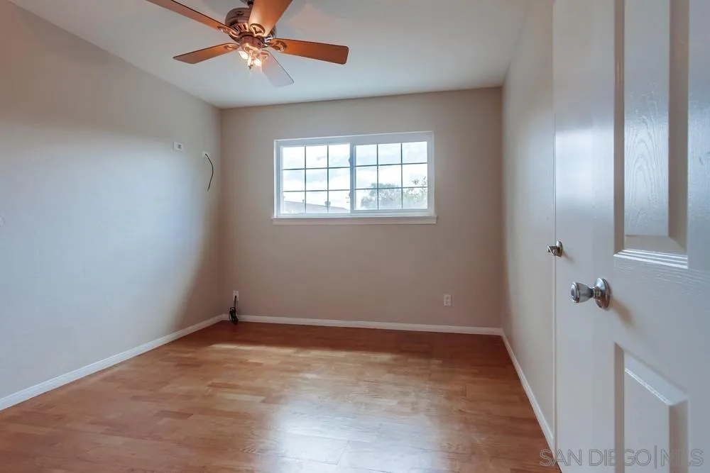 4441 Appleton Street San Diego, CA 92117 - Photo 21 of 29 wooden floor in an empty room with a window