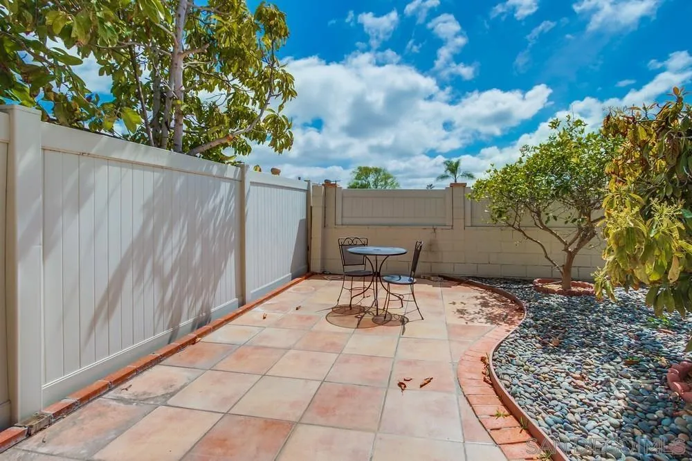 4441 Appleton Street San Diego, CA 92117 - Photo 27 of 29 a view of backyard with a table and chairs and potted plants