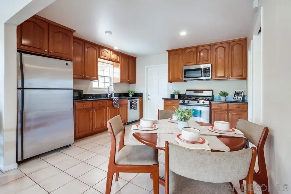 4441 Appleton Street San Diego, CA 92117 - Photo 4 of 29 a dining room with furniture a window and kitchen view