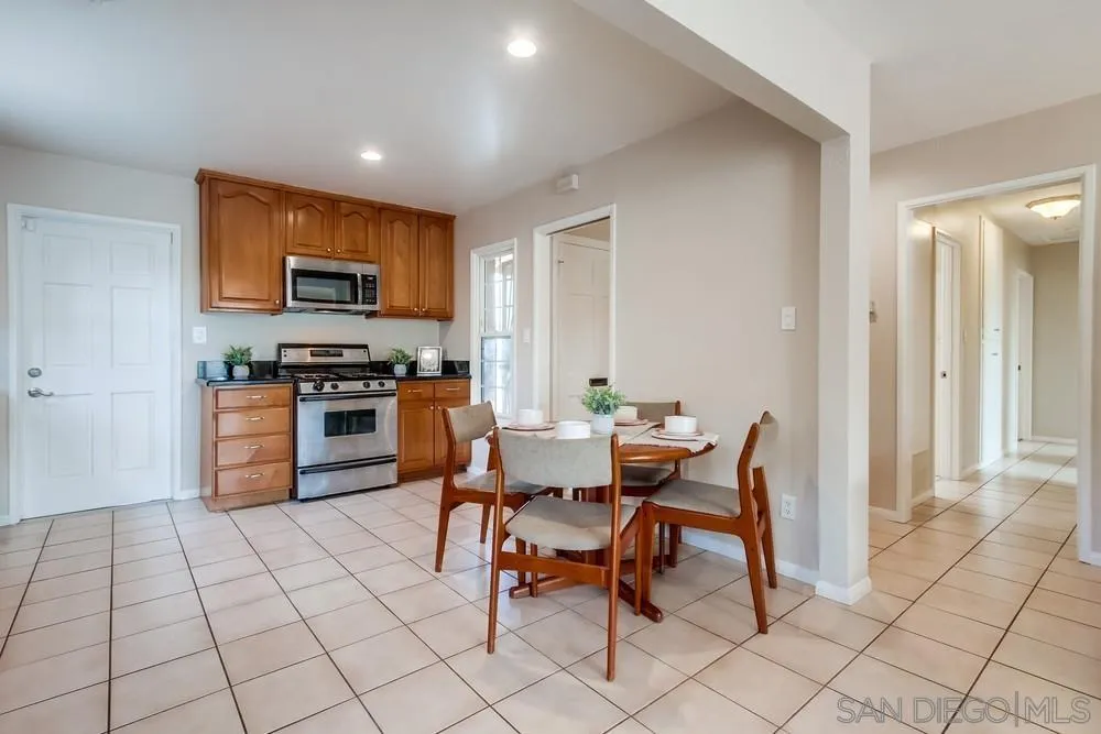 4441 Appleton Street San Diego, CA 92117 - Photo 6 of 29 a dining hall with a dining table and chairs