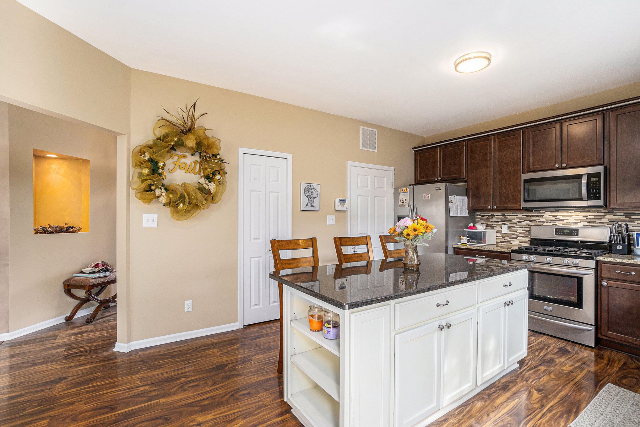12190 80th Place Dyer, IN 46311 - Photo 5 of 16 a kitchen with stainless steel appliances granite countertop a sink stove and refrigerator