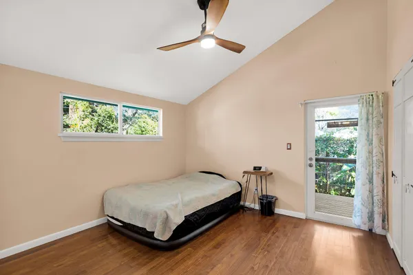 a bed sitting in a bedroom next to a window