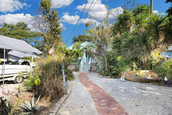 a front view of a house with a yard and a garden