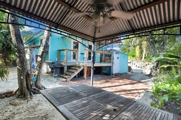 a view of a house with backyard and sitting area