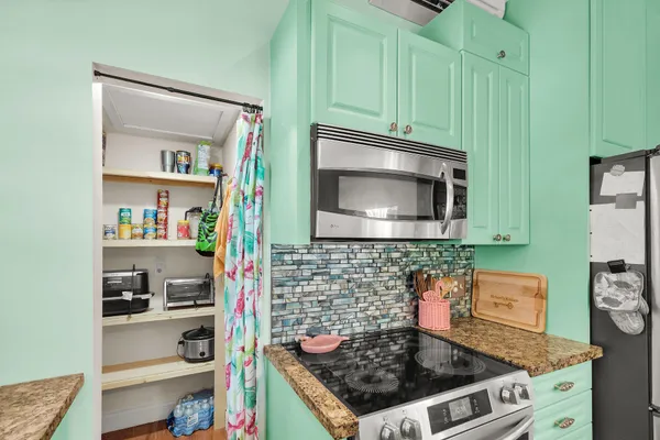 a kitchen with a stove and cabinets