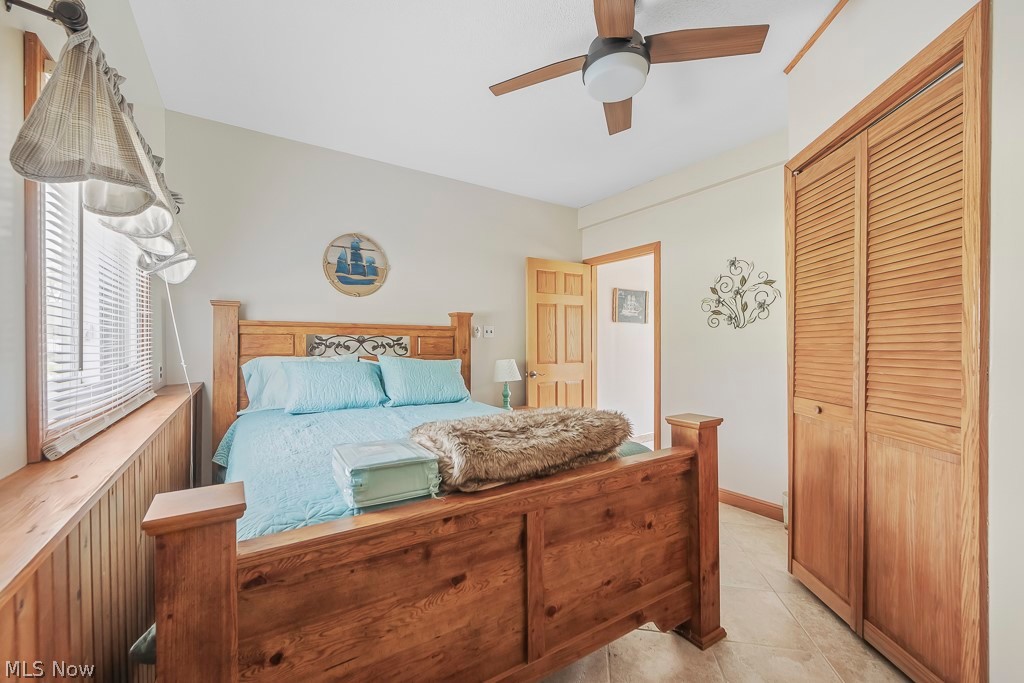 6939 Lakeview Road Hanoverton, OH 44423 - Photo 27 of 42 Bedroom featuring a closet, ceiling fan, and light ceramic tile floors