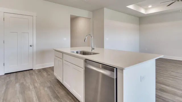 a kitchen with kitchen island white cabinets and stainless steel appliances