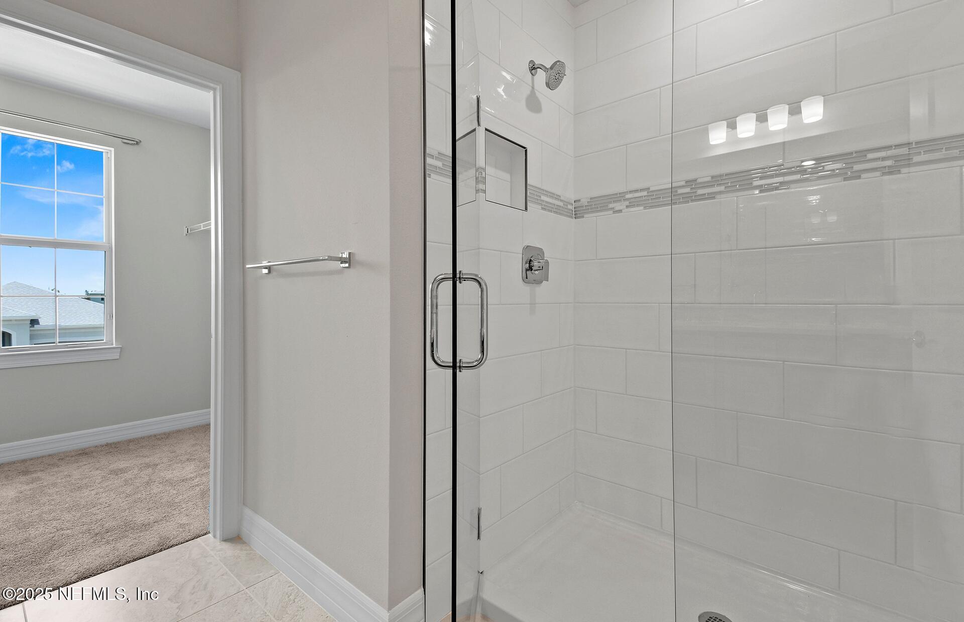 45 Blind Oak Circle St. Augustine, FL 32095 - Photo 10 of 18 a bathroom with a glass shower door