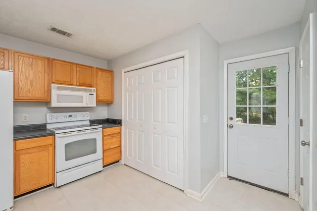 a kitchen with a stove top oven sink and cabinets