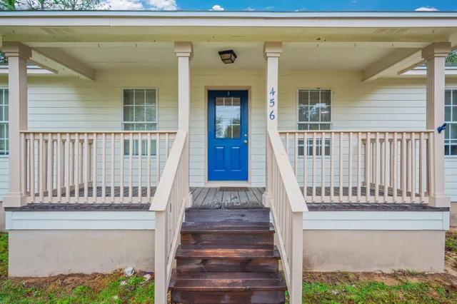 a view of staircase with white walls and a window