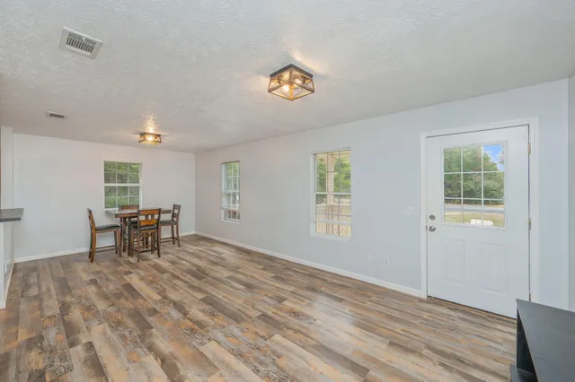 a view of empty room with window and fireplace