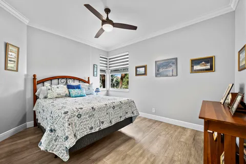 a bedroom with a bed a window and a chandelier