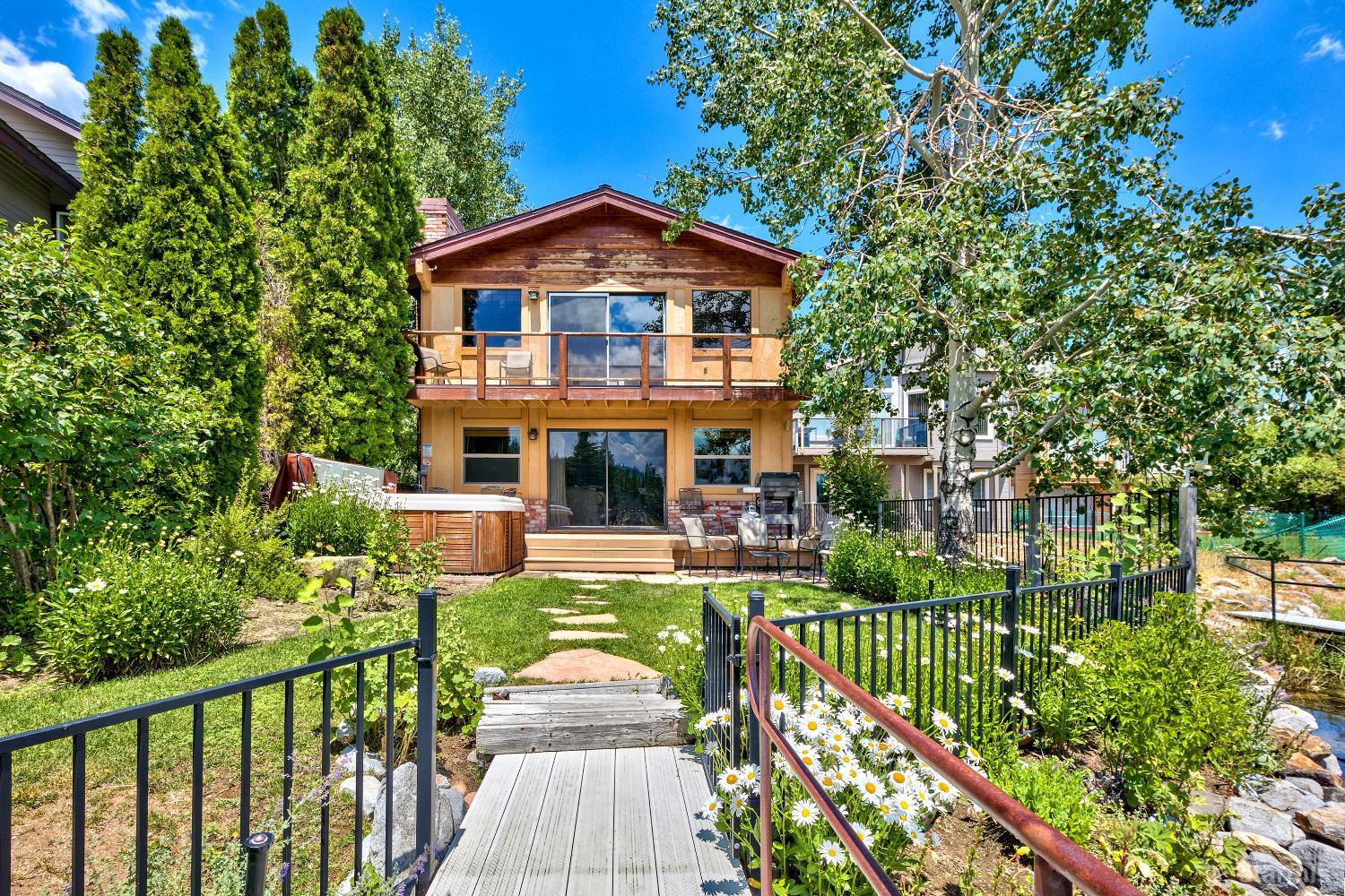 1886 Cascade Court South Lake Tahoe, CA 96150 - Photo 1 of 39 a front view of a house with a yard table and chairs