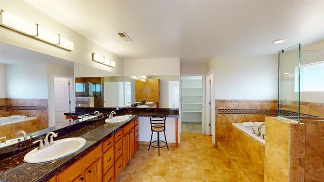 a spacious bathroom with a granite countertop sink and a large mirror