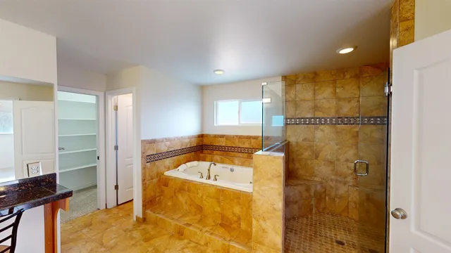 a bathroom with a tub and shower