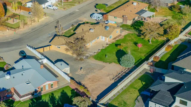 an aerial view of a houses with yard