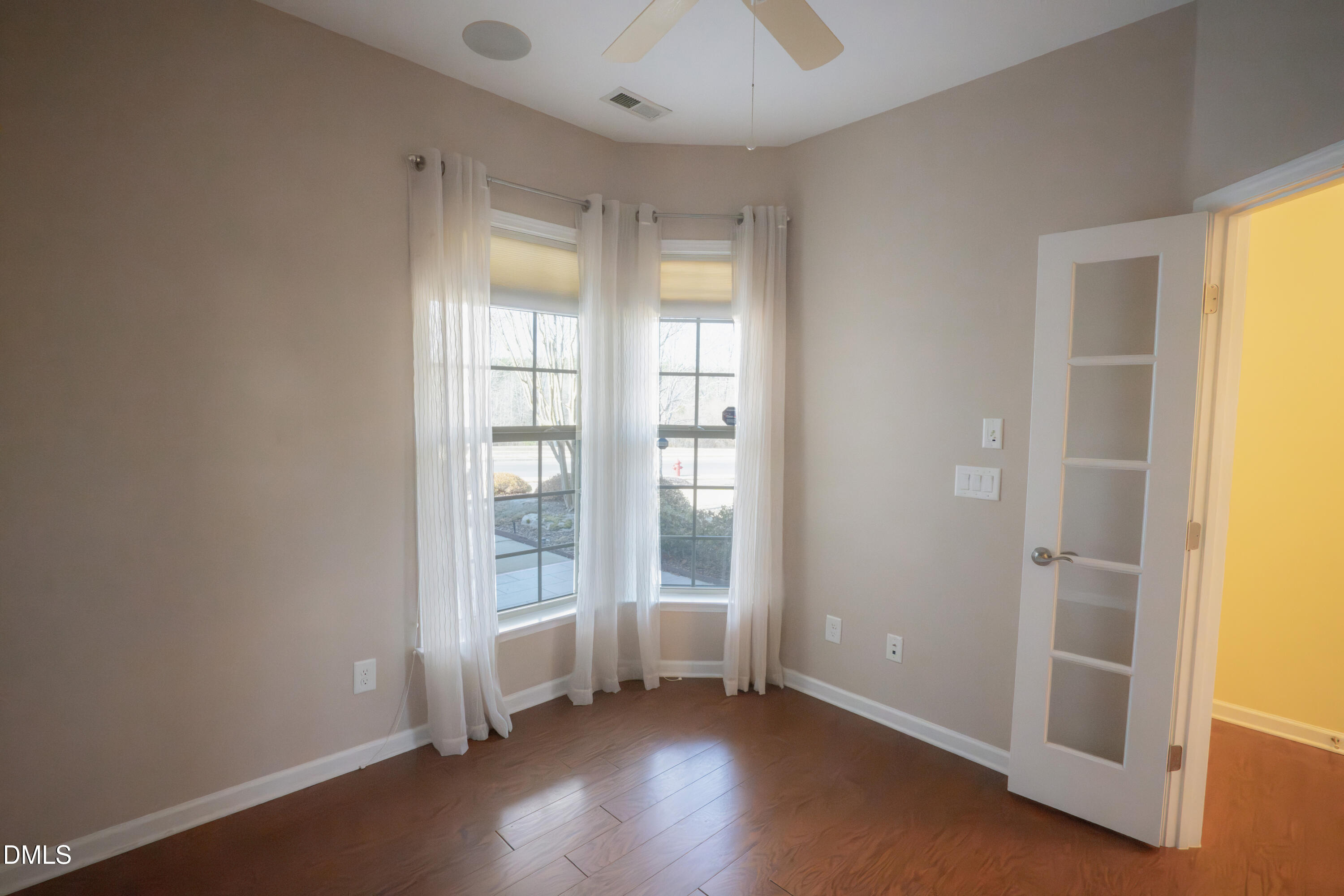 314 Rosedale Creek Drive Durham, NC 27703 - Photo 21 of 33 an empty room with wooden floor and windows