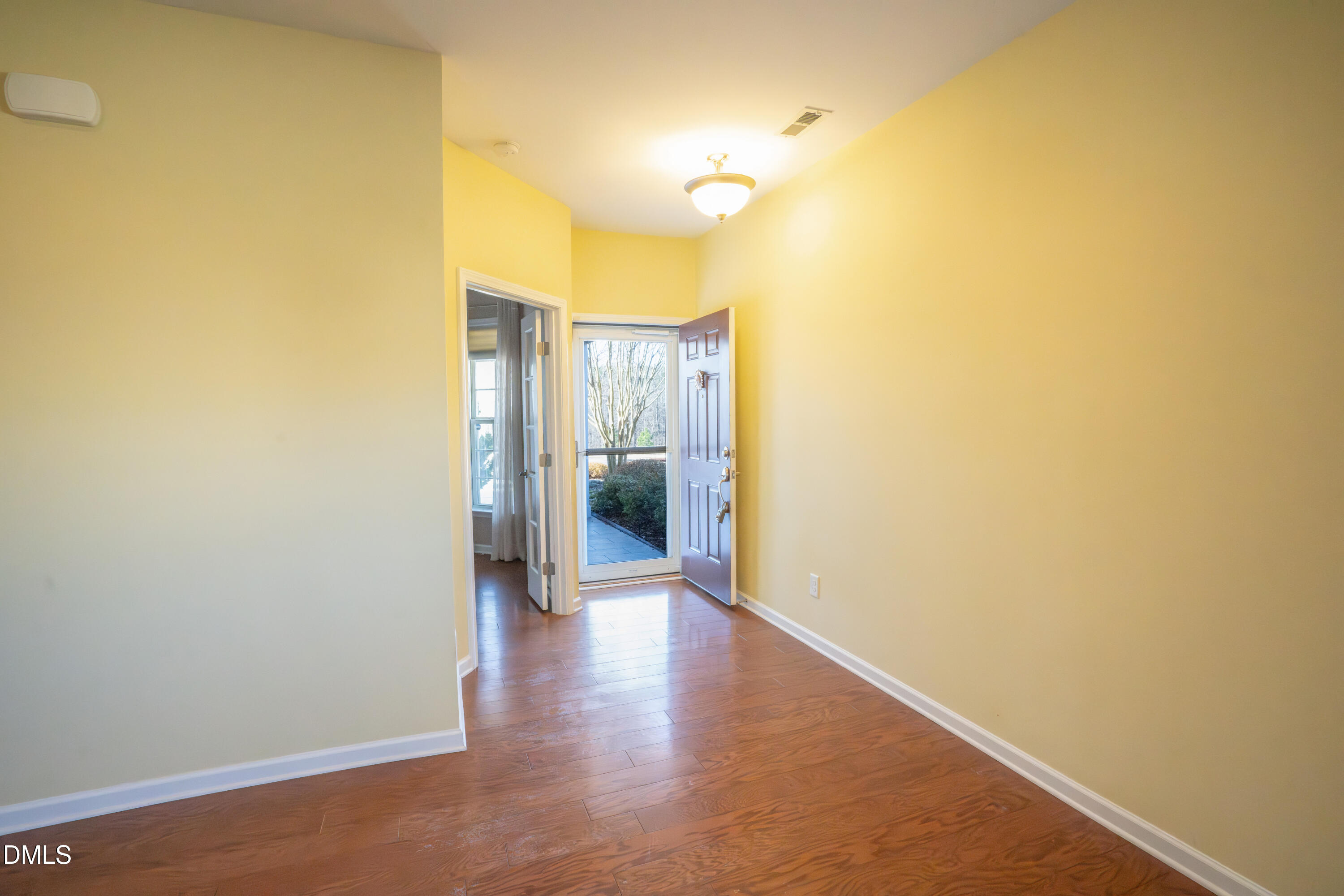 314 Rosedale Creek Drive Durham, NC 27703 - Photo 5 of 33 a view of a hallway with wooden floor