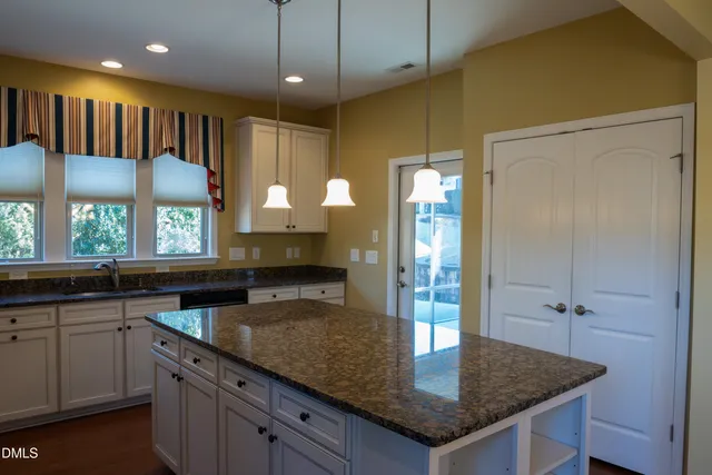 a kitchen with a counter space a sink appliances and cabinets