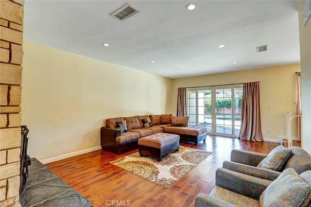 a living room with furniture window and a wooden floor
