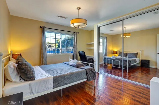 a bedroom with a bed and a chandelier