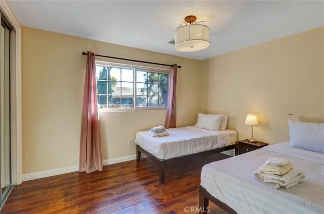 a bedroom with two beds and a window