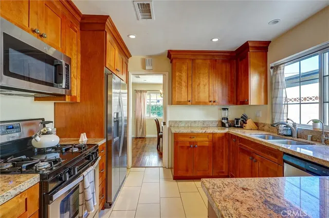 a kitchen with stainless steel appliances a stove sink microwave and cabinets