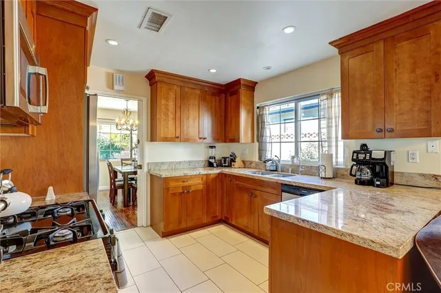 a kitchen with stainless steel appliances granite countertop sink stove and cabinets