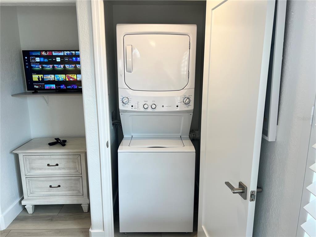 6154 Midnight Pass Road, Unit A15 Sarasota, FL 34242 - Photo 11 of 17 a utility room with dryer and washer