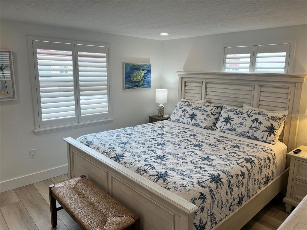 6154 Midnight Pass Road, Unit A15 Sarasota, FL 34242 - Photo 13 of 17 a bedroom with a bed and a window