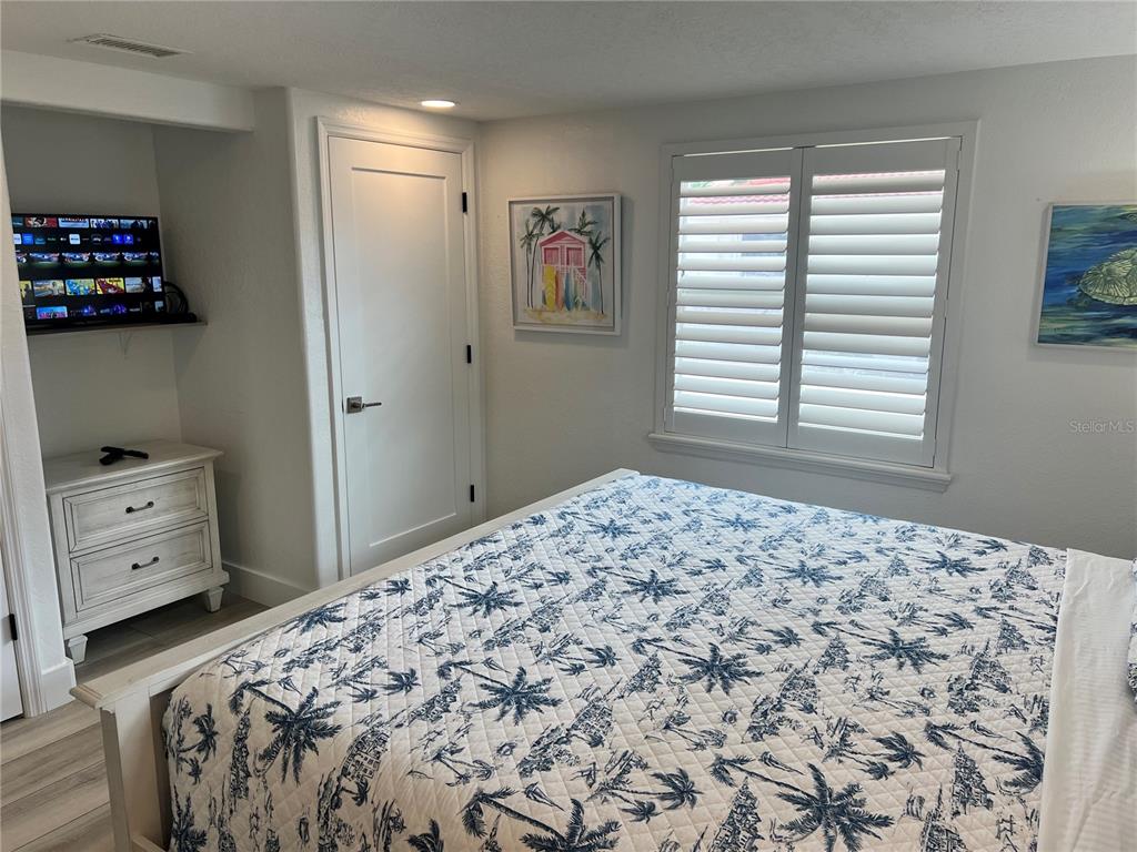 6154 Midnight Pass Road, Unit A15 Sarasota, FL 34242 - Photo 14 of 17 a bedroom with a bed and a window