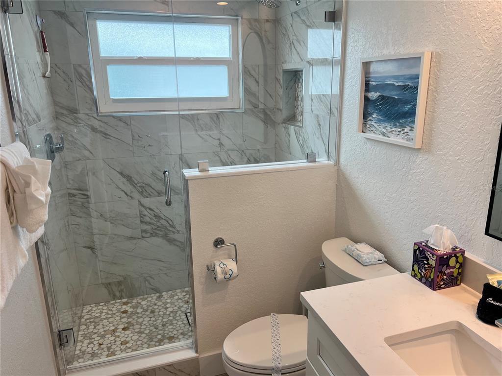 6154 Midnight Pass Road, Unit A15 Sarasota, FL 34242 - Photo 15 of 17 a bathroom with a sink toilet and shower