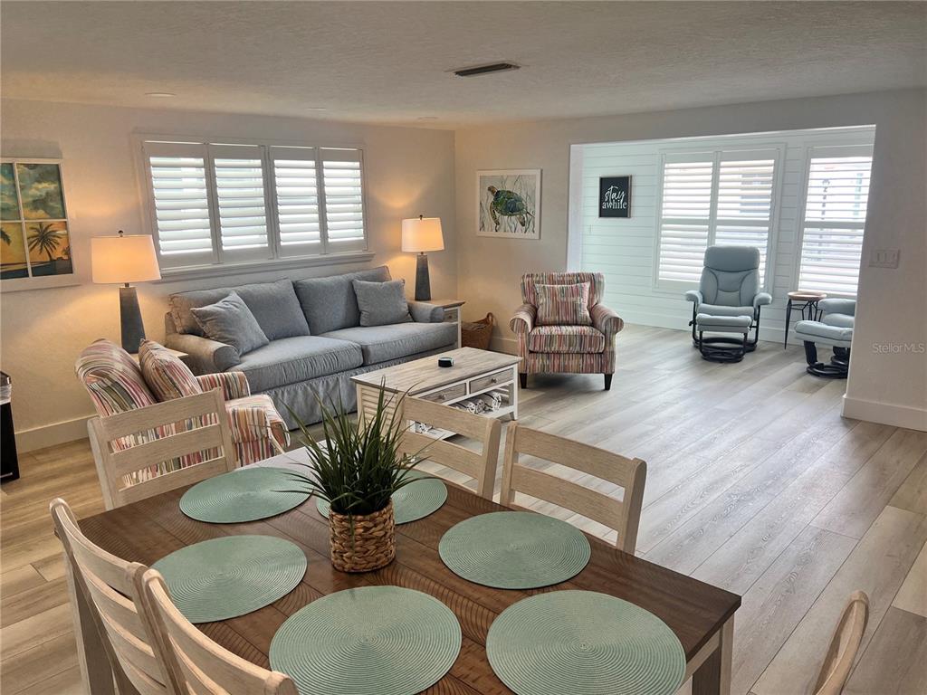 6154 Midnight Pass Road, Unit A15 Sarasota, FL 34242 - Photo 3 of 17 a living room with furniture and wooden floor