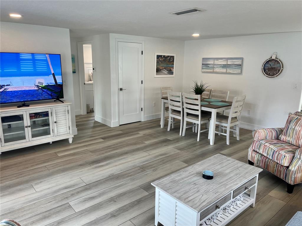 6154 Midnight Pass Road, Unit A15 Sarasota, FL 34242 - Photo 7 of 17 a living room with furniture and a wooden floor