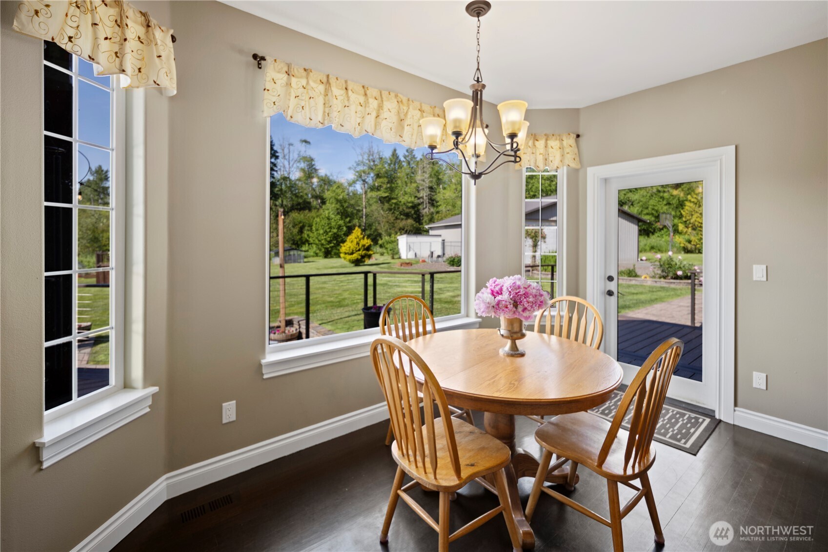 14905 218th Street Southeast Monroe, WA 98272 - Photo 17 of 40 a dining room with furniture a chandelier and window