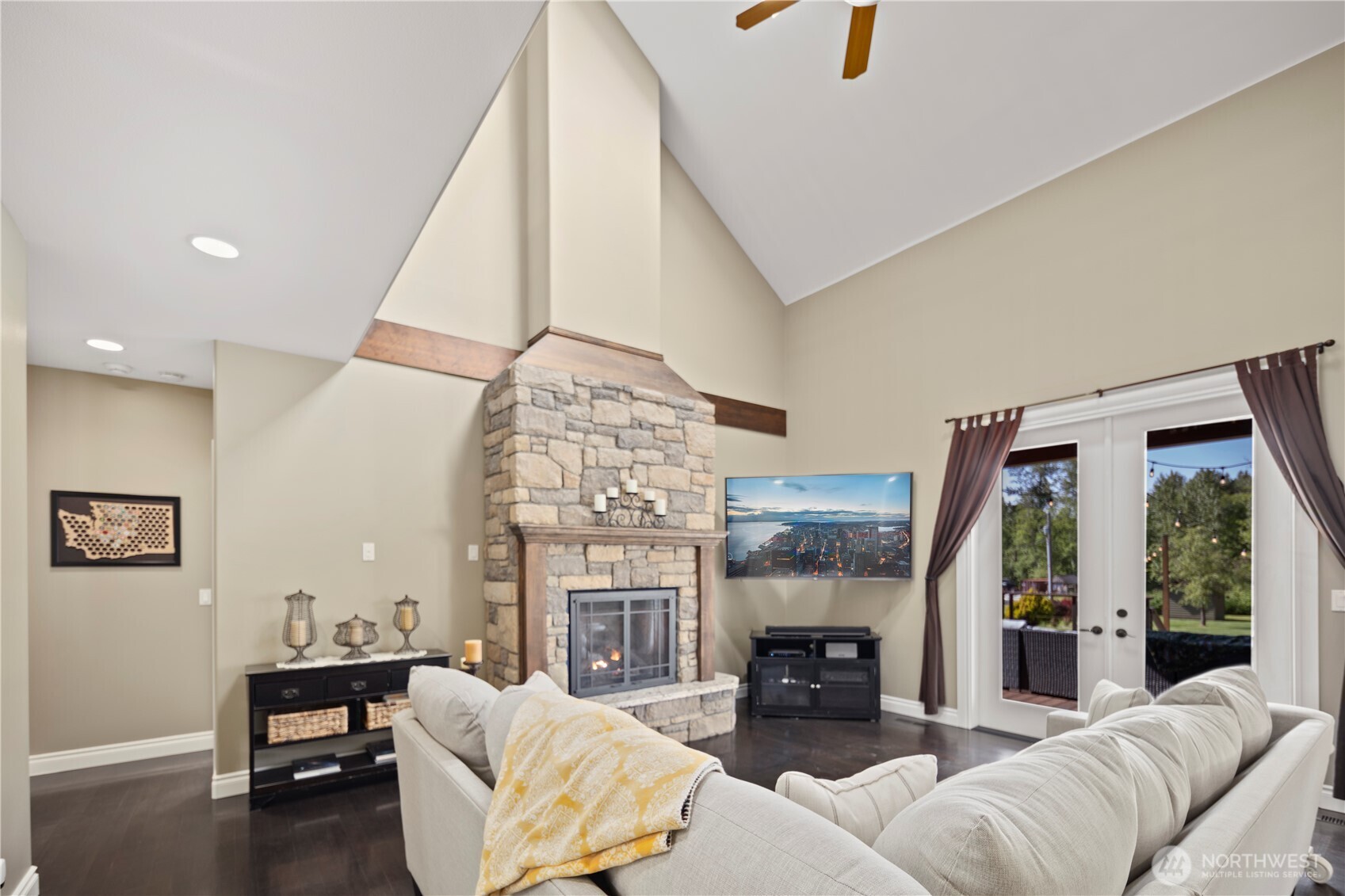 14905 218th Street Southeast Monroe, WA 98272 - Photo 20 of 40 a living room with furniture a fireplace and a chandelier