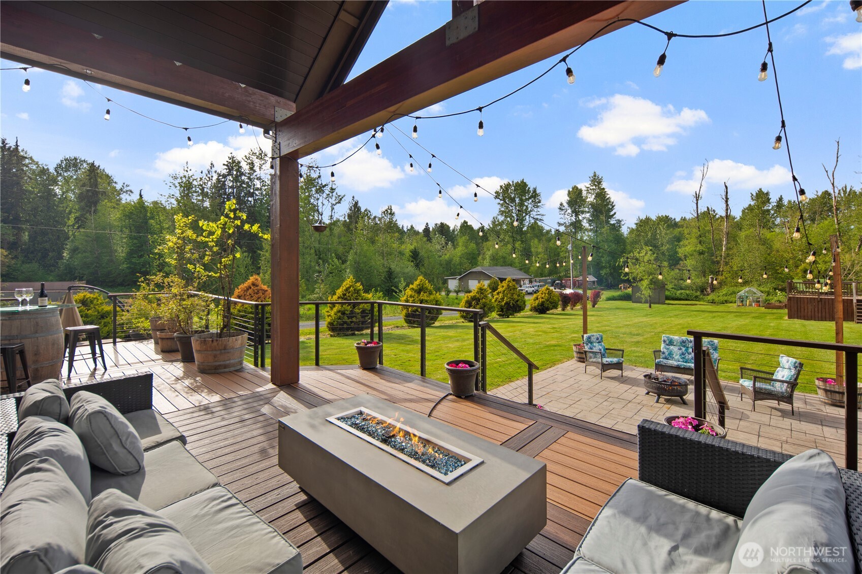 14905 218th Street Southeast Monroe, WA 98272 - Photo 40 of 40 a view of a patio with couches table and chairs under an umbrella