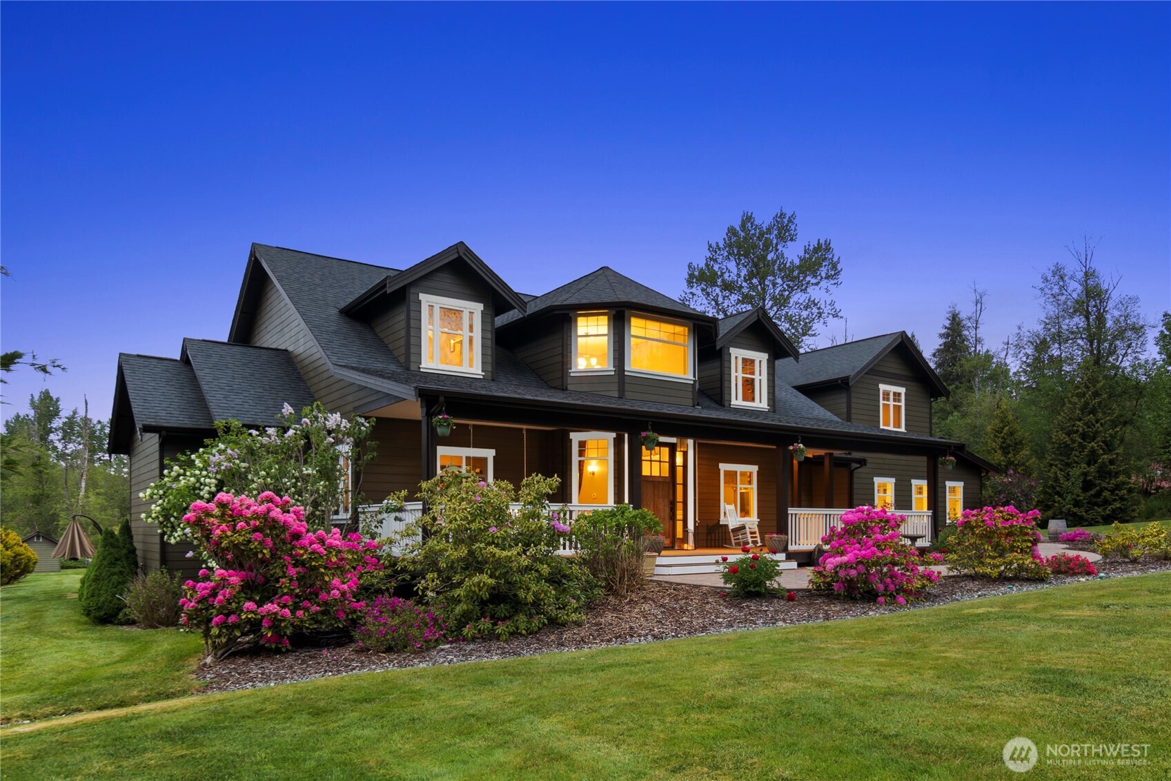 14905 218th Street Southeast Monroe, WA 98272 - Photo 5 of 40 a front view of a house with a garden and seating space