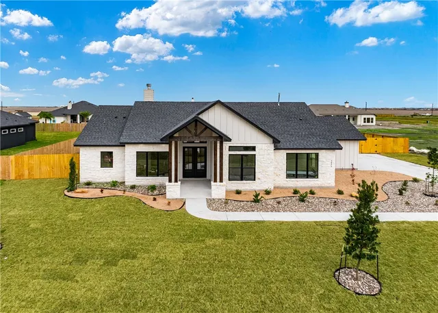 a view of a house with backyard patio and swimming pool