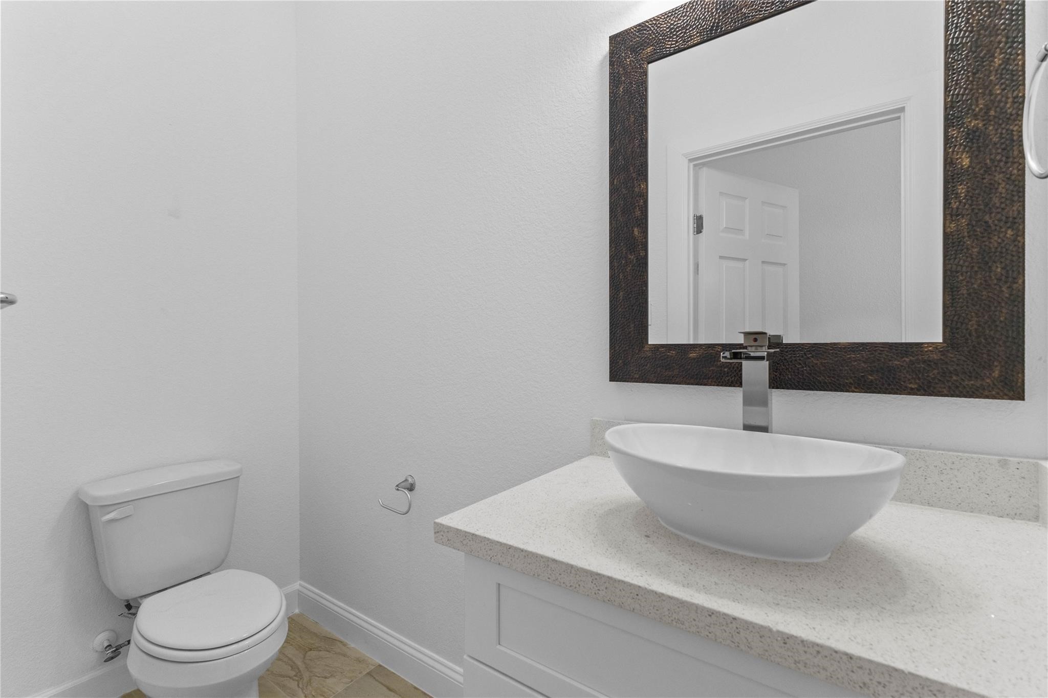 7805 Farnsworth Street, Unit B Houston, TX 77022 - Photo 15 of 26 a bathroom with a sink a toilet and mirror