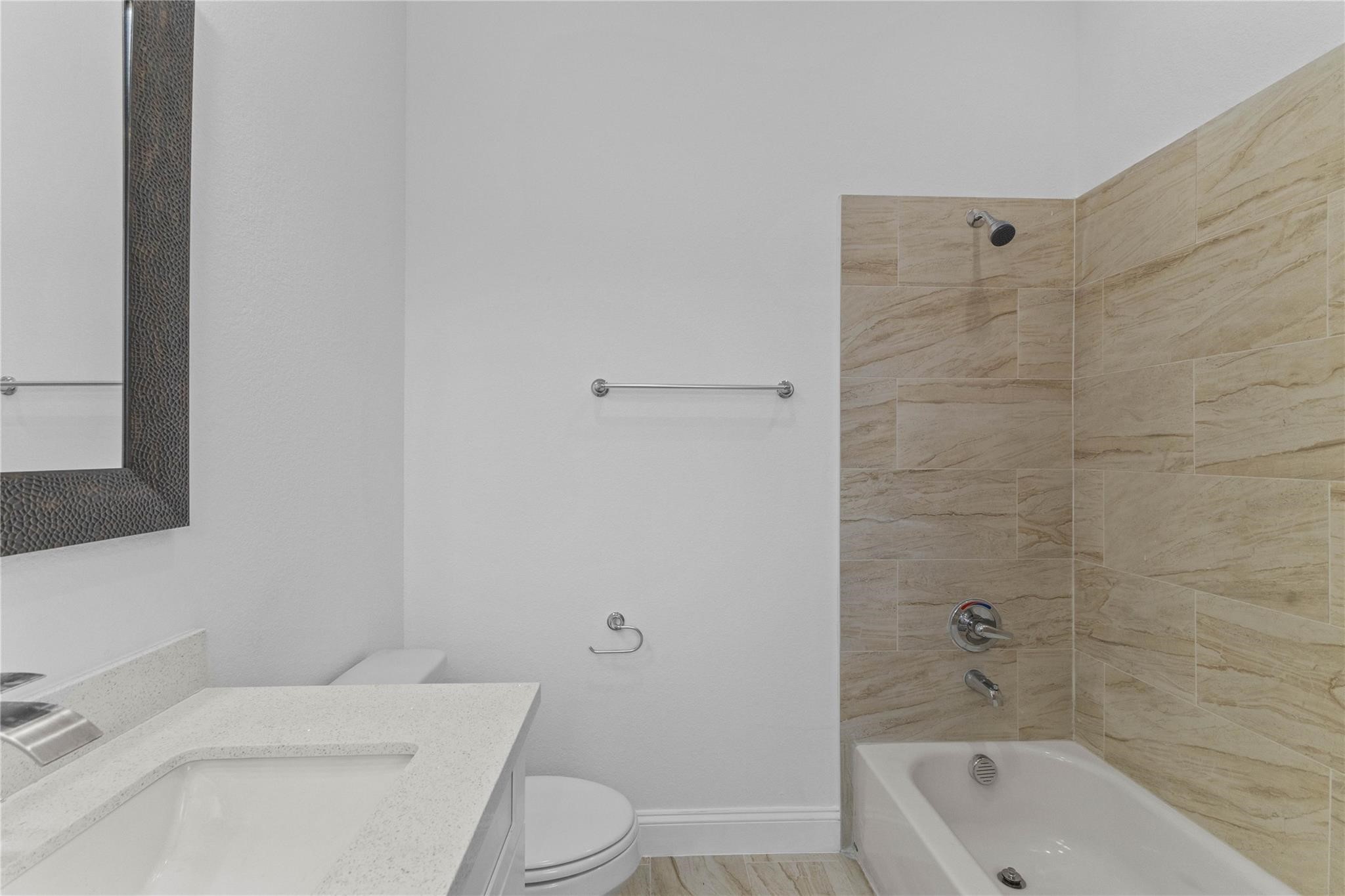 7805 Farnsworth Street, Unit B Houston, TX 77022 - Photo 23 of 26 a bathroom with a sink a toilet and bathtub