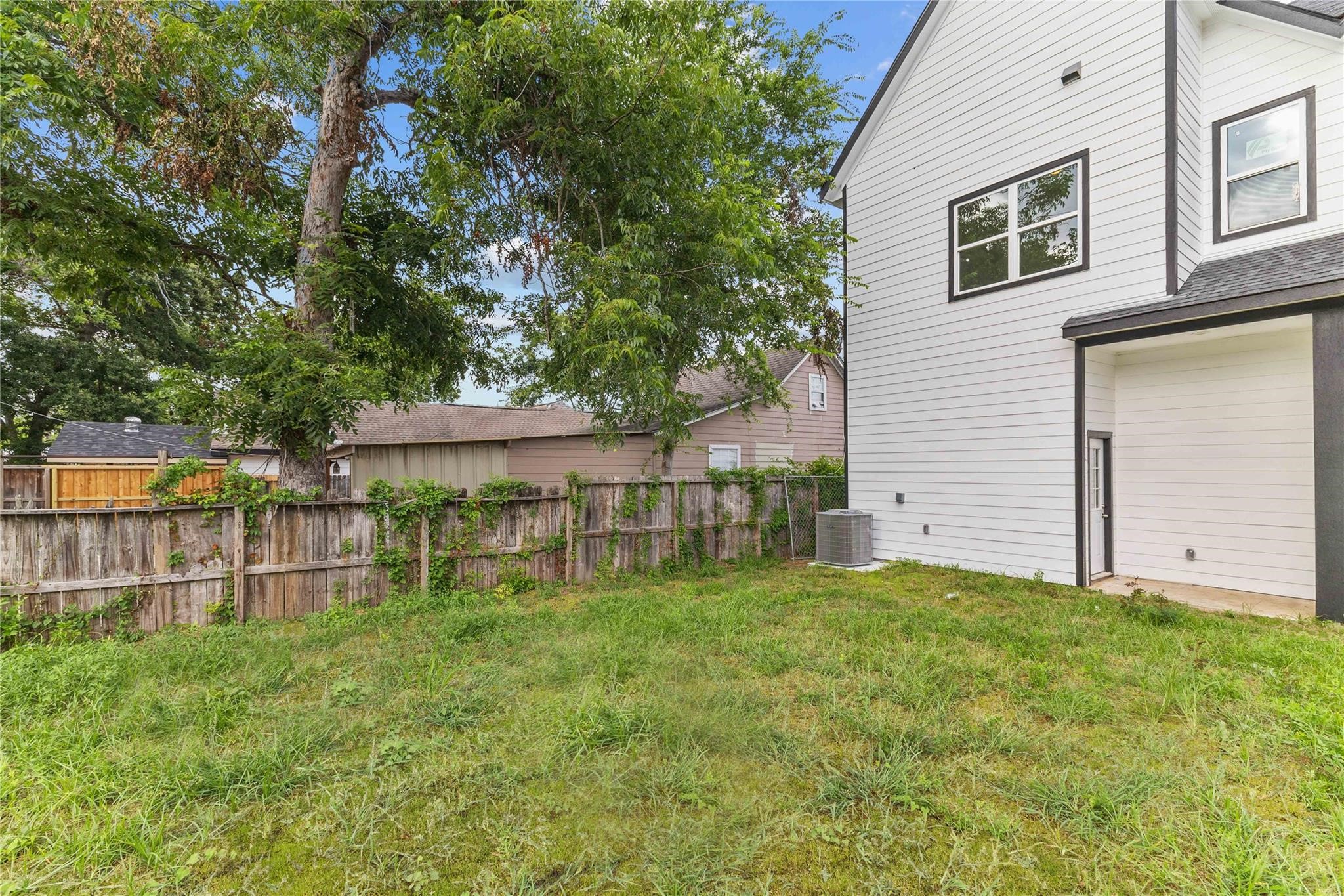 7805 Farnsworth Street, Unit B Houston, TX 77022 - Photo 25 of 26 a view of a house with a yard and sitting area