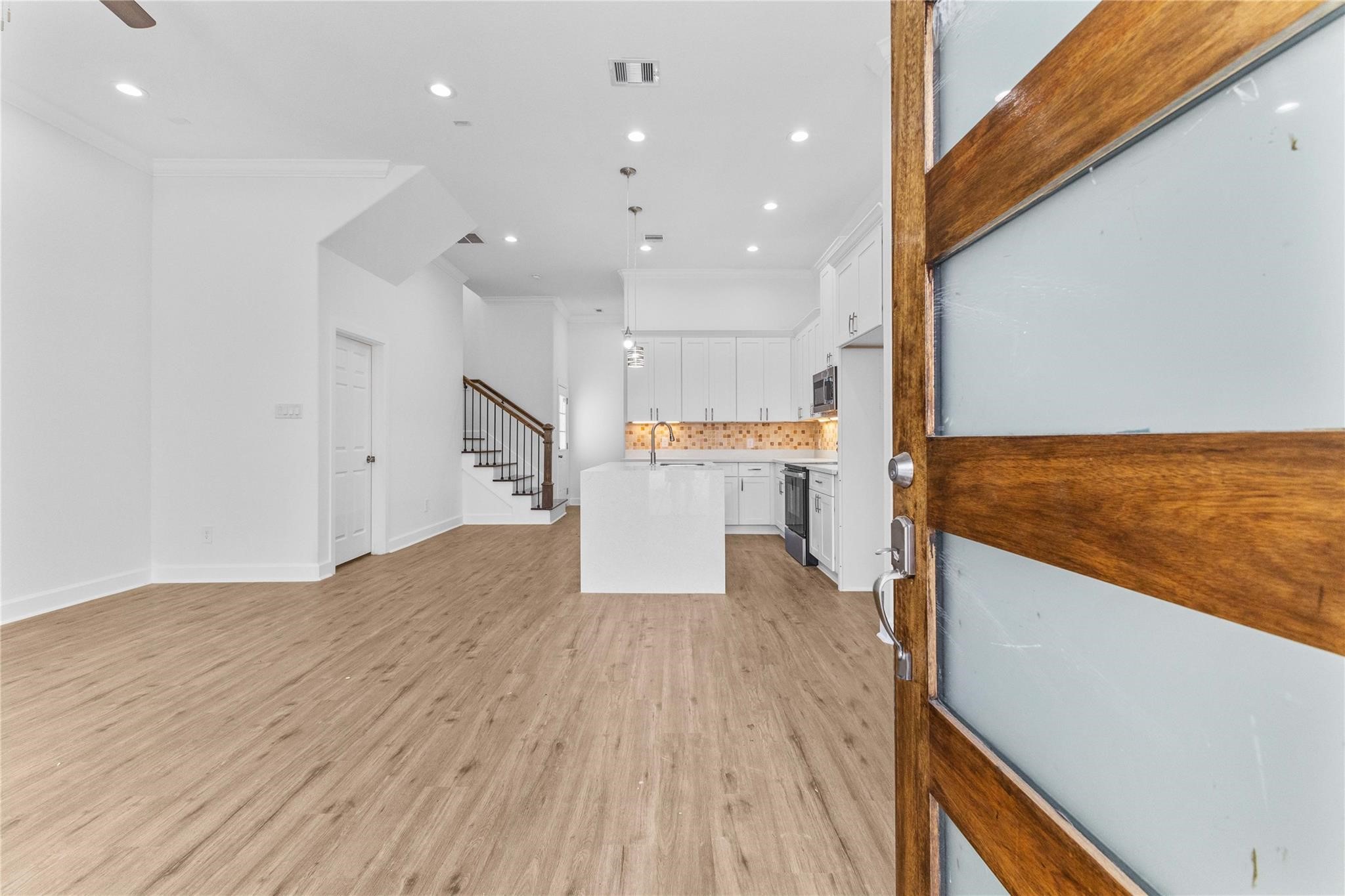 7805 Farnsworth Street, Unit B Houston, TX 77022 - Photo 3 of 26 a view of kitchen with wooden floor
