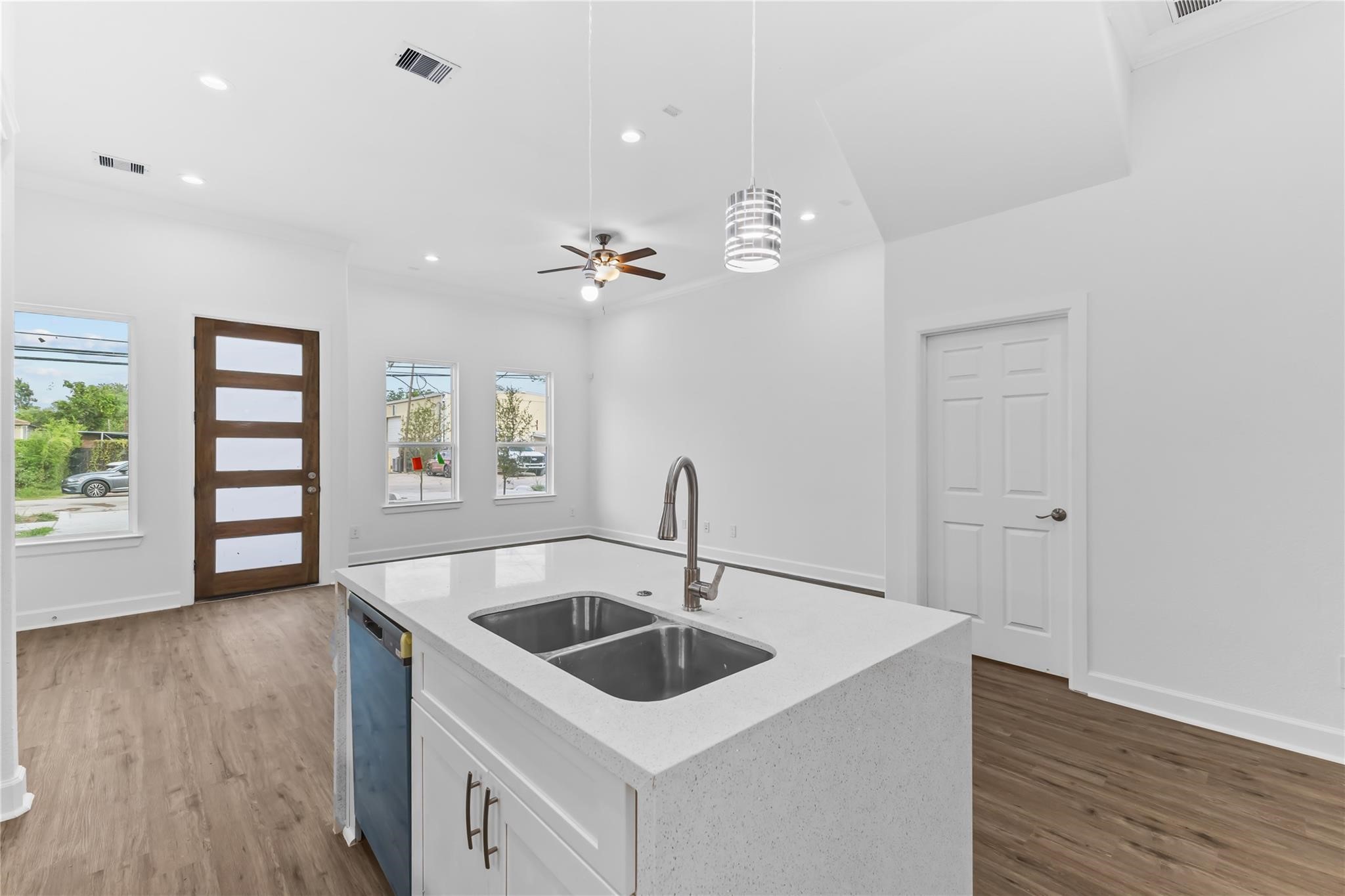 7805 Farnsworth Street, Unit B Houston, TX 77022 - Photo 5 of 26 a kitchen with a sink cabinets and wooden floor