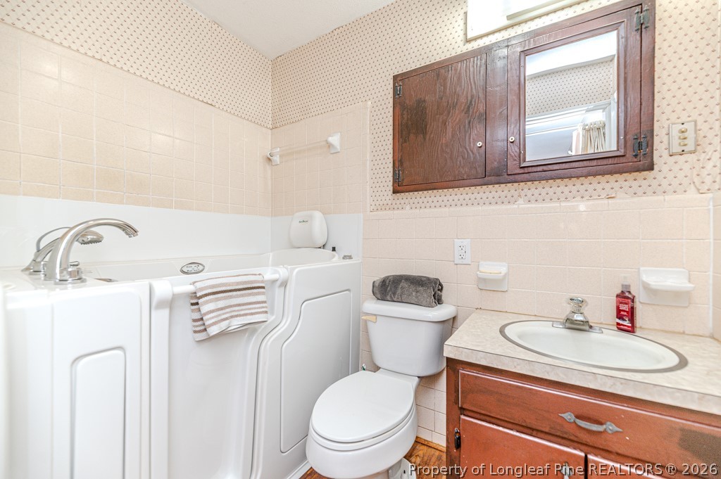 3384 Goldston Glendon Road Goldston, NC 27252 - Photo 22 of 47 a white toilet sitting next to a bathroom sink