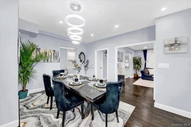 a view of a dining room with furniture wooden floor and chandelier