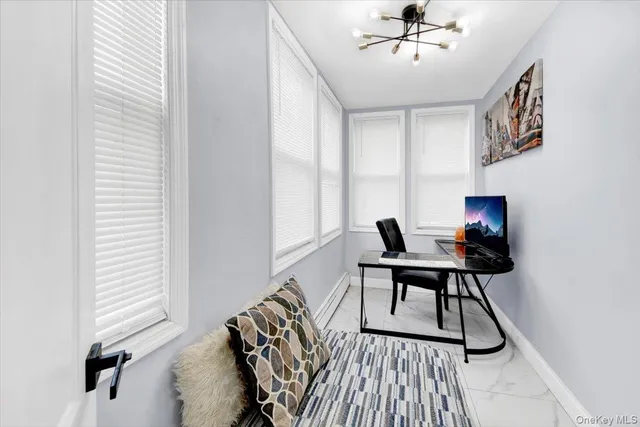 a workspace with wooden floor and a window