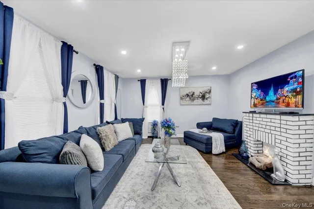 a living room with fireplace furniture and a flat screen tv