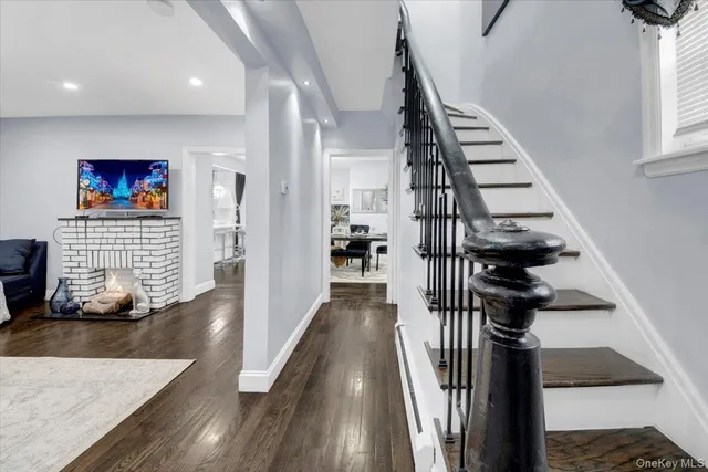 a view of entryway and hall with wooden floor