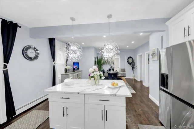 a kitchen with sink refrigerator and microwave
